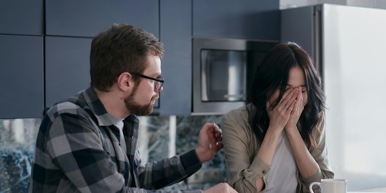 Photo of a couple who appear to be experiencing distress